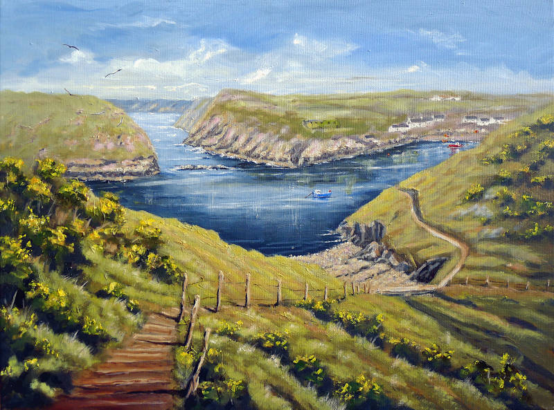 A oil painting of Abercastle in Pembrokeshire, the view looking down into the beautiful harbour from the coast path with fishing boats on the water and houses in the village.
