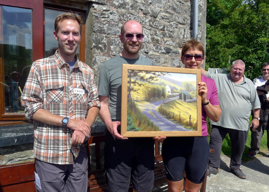 Artist holding a commisioned painting