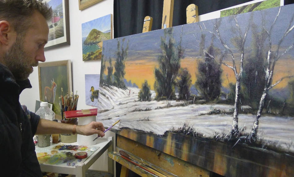 Welsh artist Chris Chalk painting in his art studio