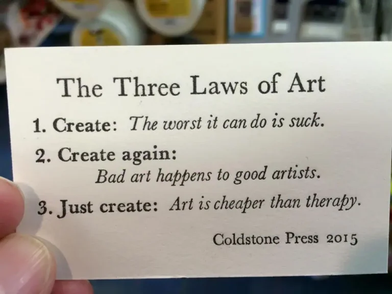 The three laws of art quote written on a piece of card.